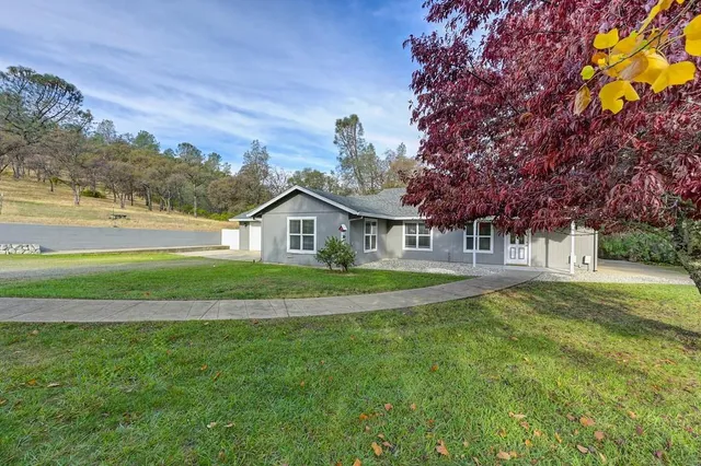 a front view of a house with a yard