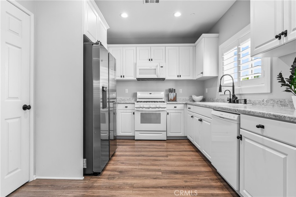 35114 Persano Place Fallbrook, CA 92028 - Photo 14 of 45 a kitchen with white cabinets stainless steel appliances and sink