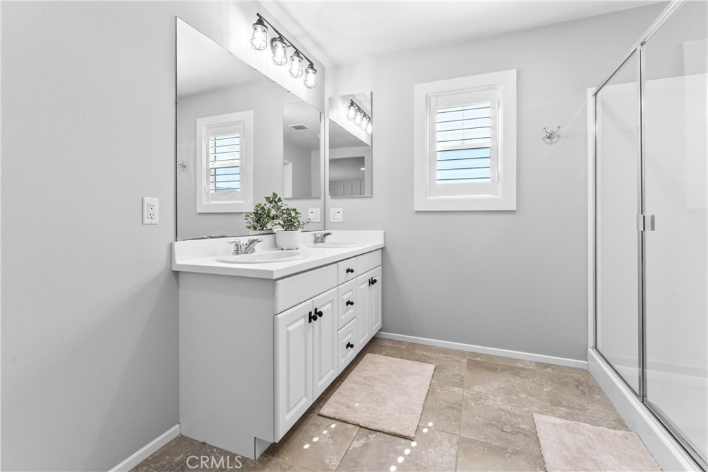 35114 Persano Place Fallbrook, CA 92028 - Photo 21 of 45 a bathroom with a sink vanity and mirror
