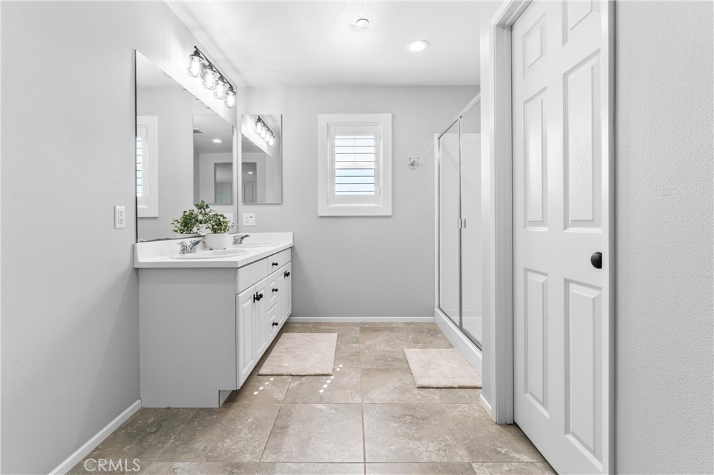 35114 Persano Place Fallbrook, CA 92028 - Photo 22 of 45 a bathroom with a sink a mirror and a vanity