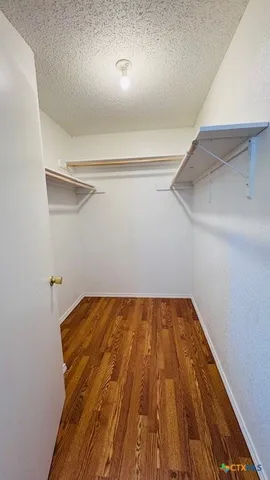 a view of a room with wooden floor