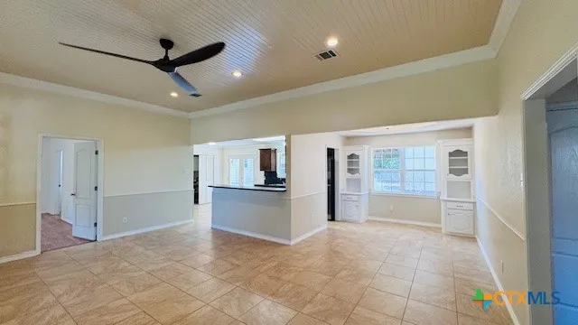 a large white kitchen with a stove and a refrigerator