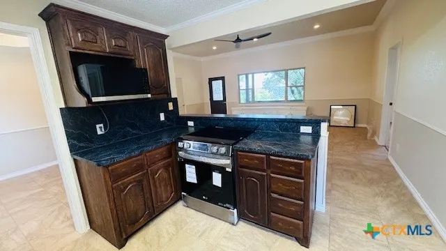 a kitchen with granite countertop a stove and a sink