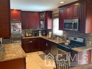 344 Union Avenue Middlesex, NJ 08846 - Photo 5 of 22 a kitchen with kitchen island granite countertop a sink stove and cabinets