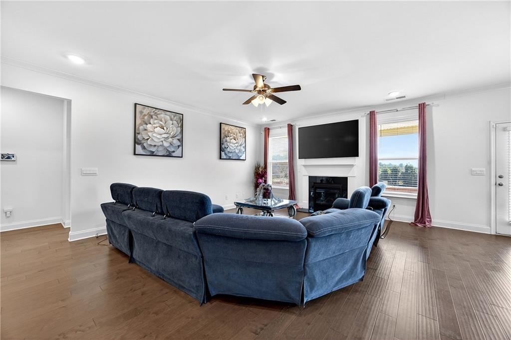 419 Beachview Road Hampton, GA 30228 - Photo 12 of 32 a living room with furniture a fireplace and a flat screen tv