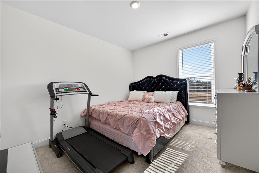 419 Beachview Road Hampton, GA 30228 - Photo 13 of 32 a bedroom with a bed and wooden floor