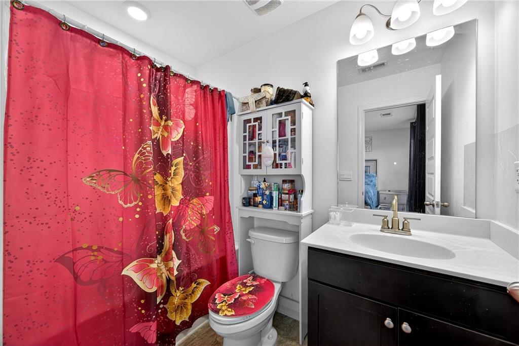 419 Beachview Road Hampton, GA 30228 - Photo 23 of 32 a bathroom with a sink a toilet and a mirror