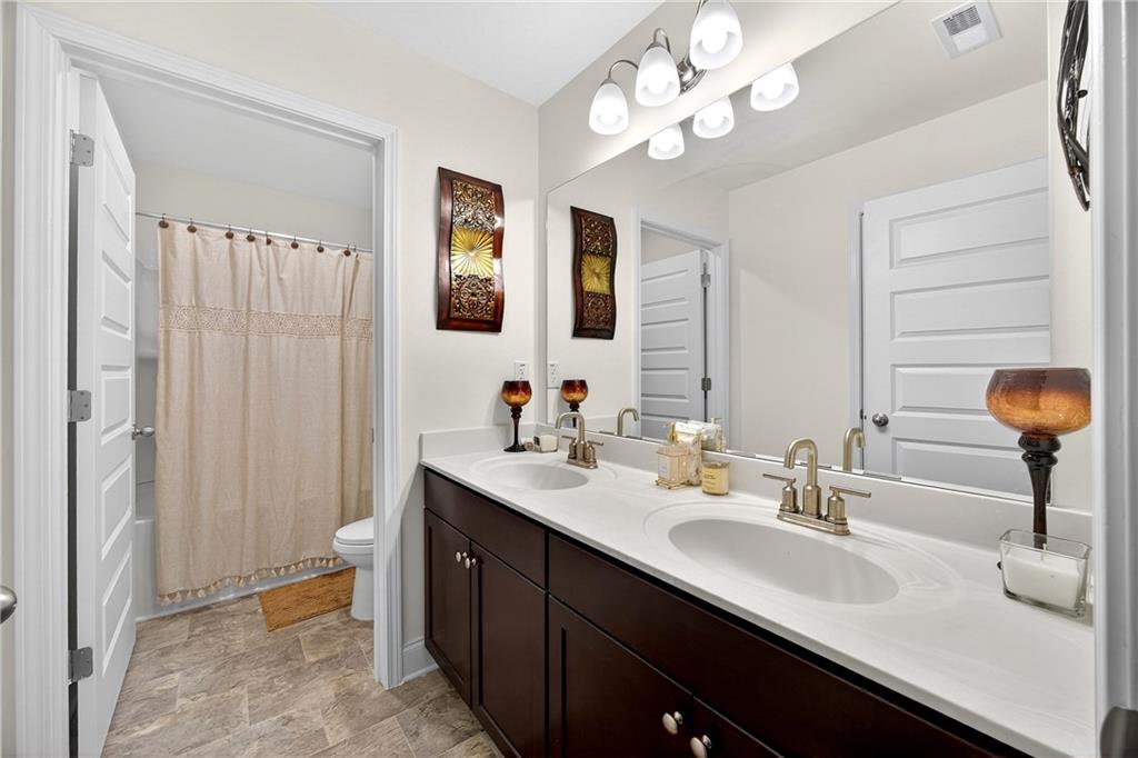 419 Beachview Road Hampton, GA 30228 - Photo 24 of 32 a bathroom with double vanity sink a vanity and a mirror