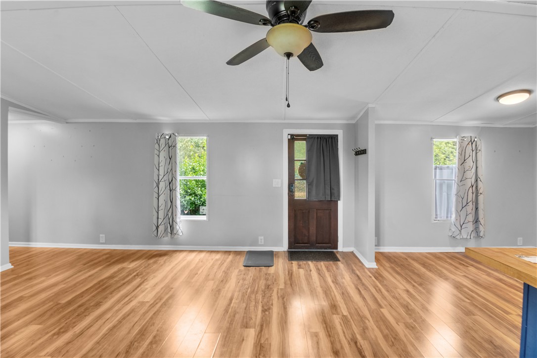 169 West Bagwell Road Liberty, SC 29657 - Photo 8 of 29 Bright open-concept living area with durable wood-look flooring and a functional ceiling fan.