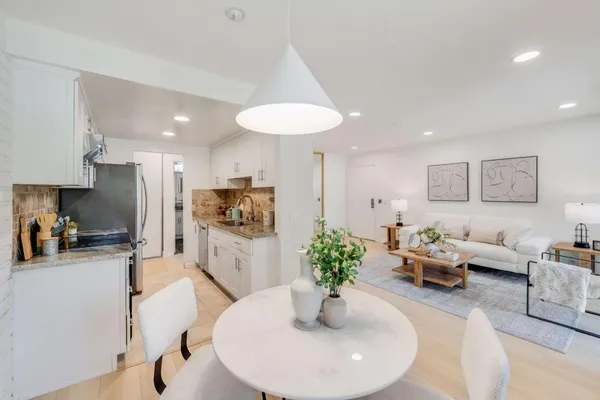 a living room with furniture potted plant and a table