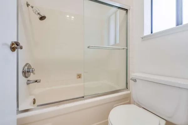 a bathroom with a toilet and a shower