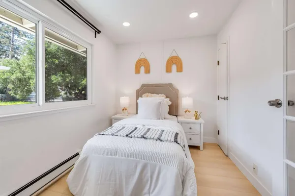a bedroom with a bed and a window
