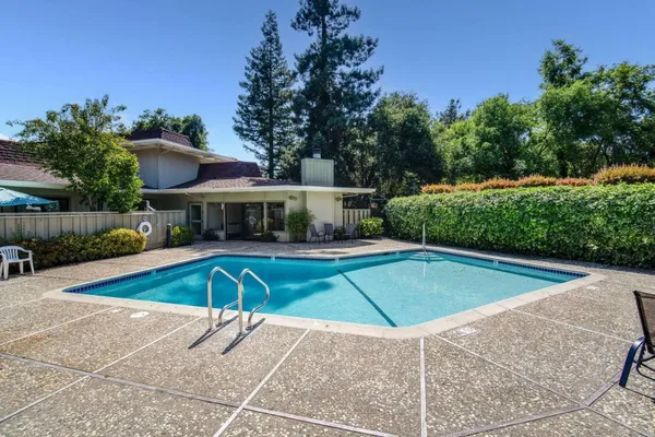 a view of a swimming pool with a patio