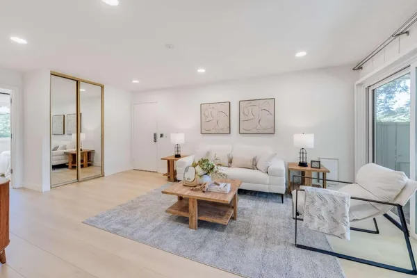 a living room with furniture and wooden floor