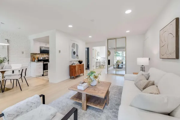 a living room with furniture and kitchen view