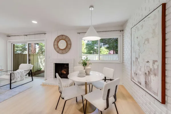a living room with furniture a fireplace and a large window