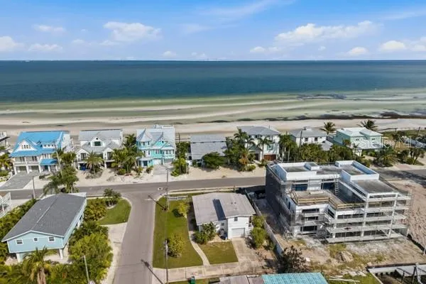 a view of swimming pool with outdoor seating and ocean view