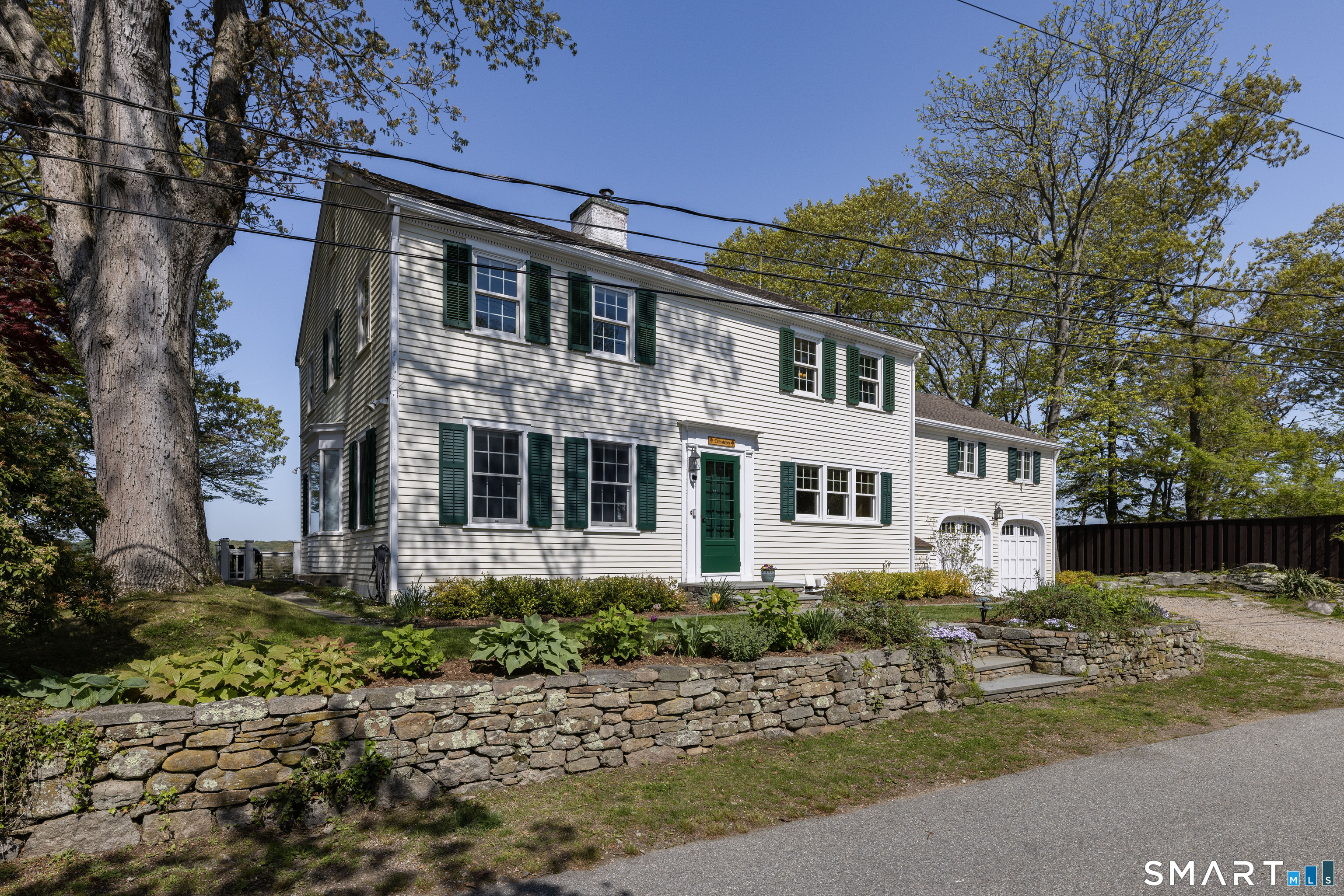 32 Money Point Road Stonington, CT 06355 - Photo 3 of 40 a front view of a house with a garden
