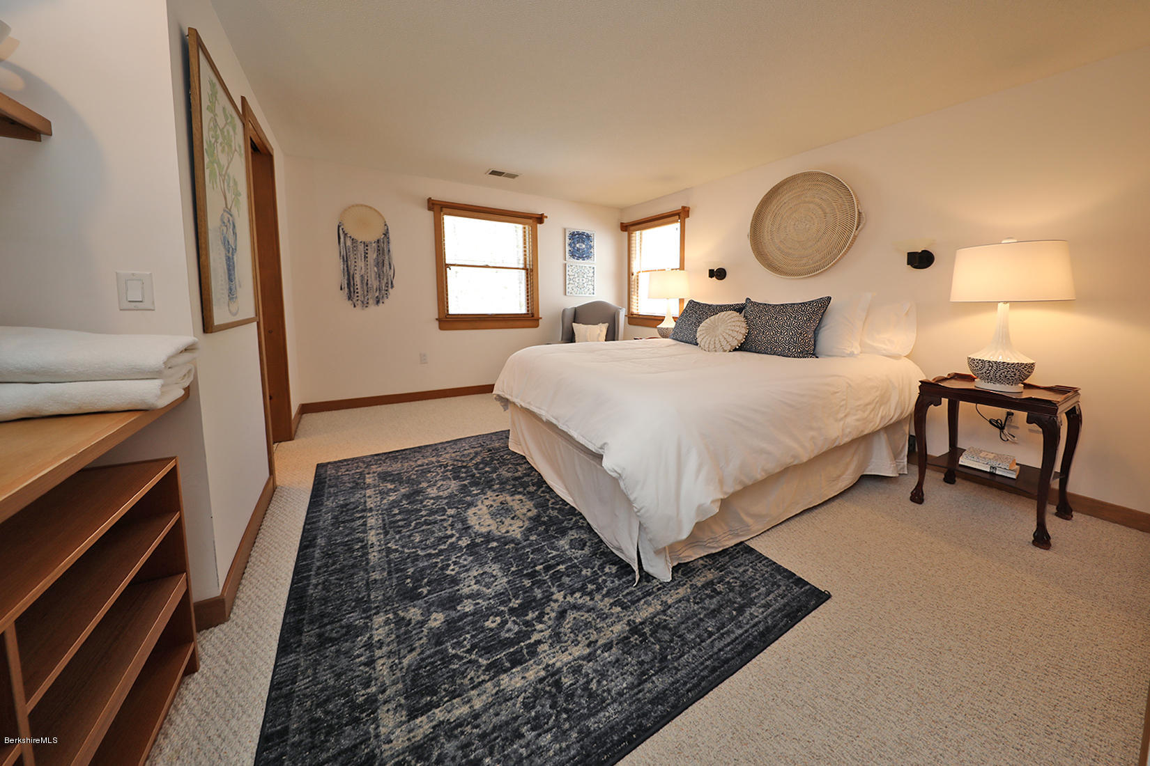183 Judd Road Otis, MA 01253 - Photo 18 of 38 a bedroom with a bed a mirror on dresser and a window
