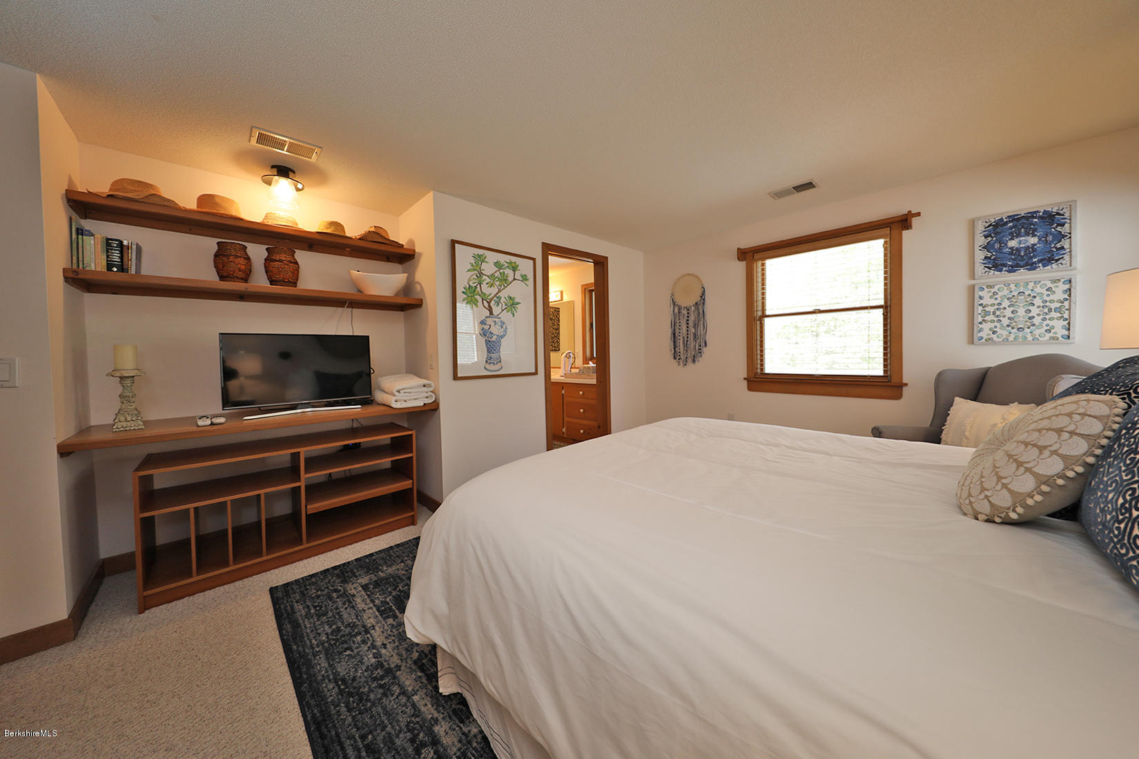 183 Judd Road Otis, MA 01253 - Photo 19 of 38 a bedroom with a bed and wooden floor