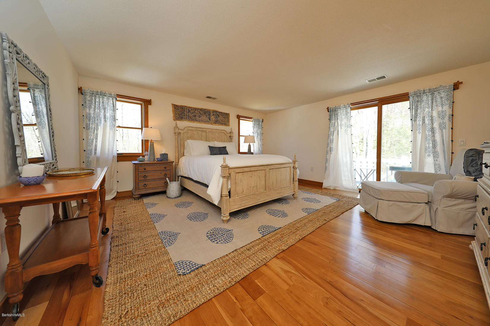 183 Judd Road Otis, MA 01253 - Photo 21 of 38 a spacious bedroom with a bed and large windows