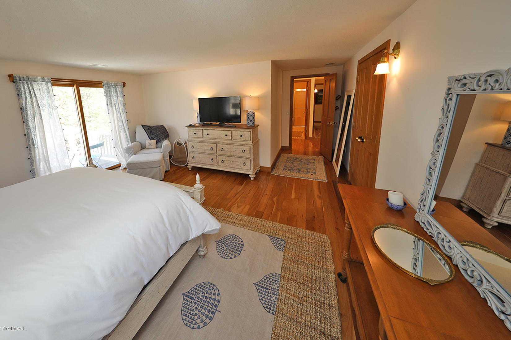 183 Judd Road Otis, MA 01253 - Photo 23 of 38 a bedroom with a bed and flat tv screen on dresser