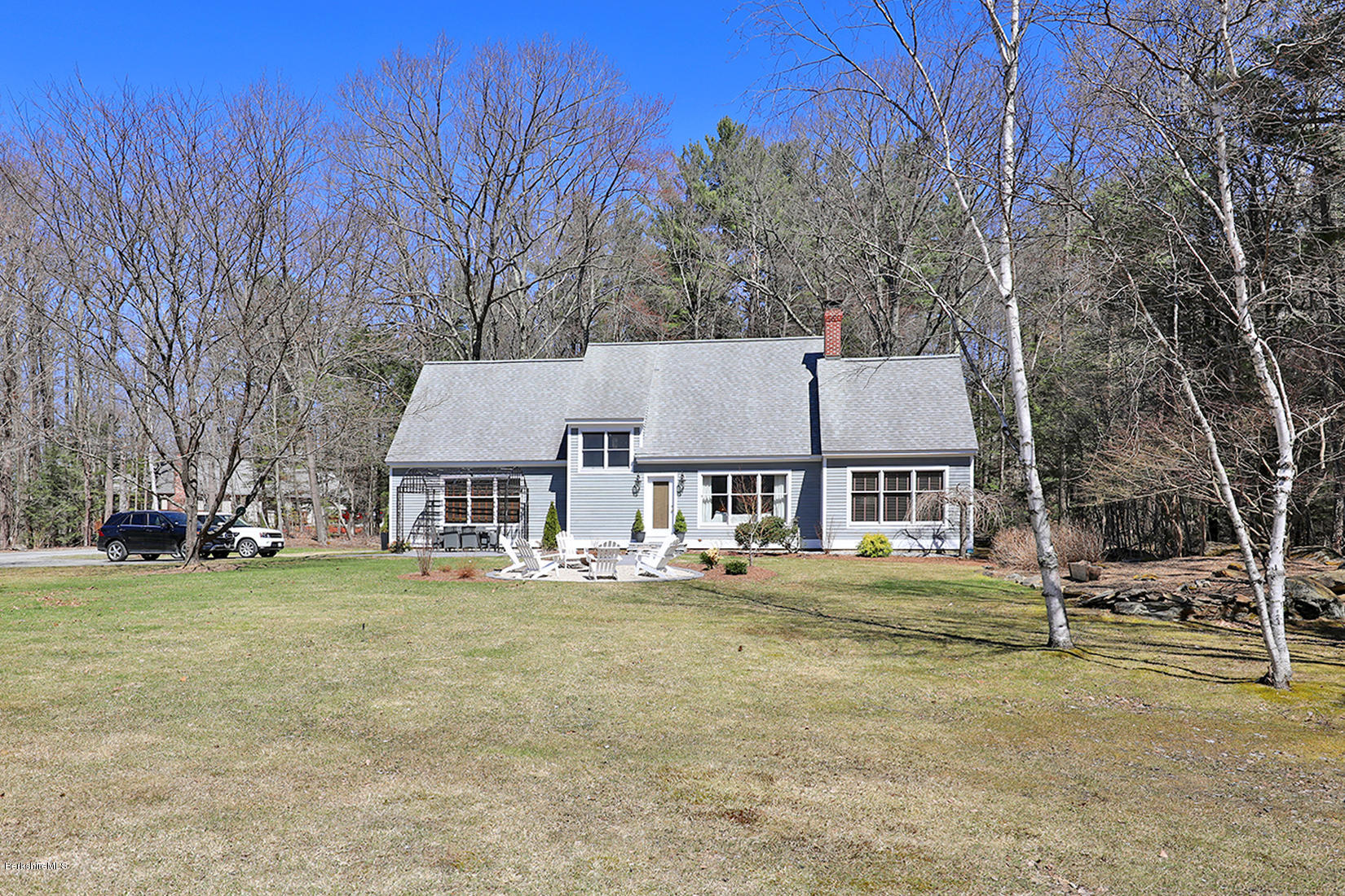 183 Judd Road Otis, MA 01253 - Photo 31 of 38 front view of a house with a big yard and large trees