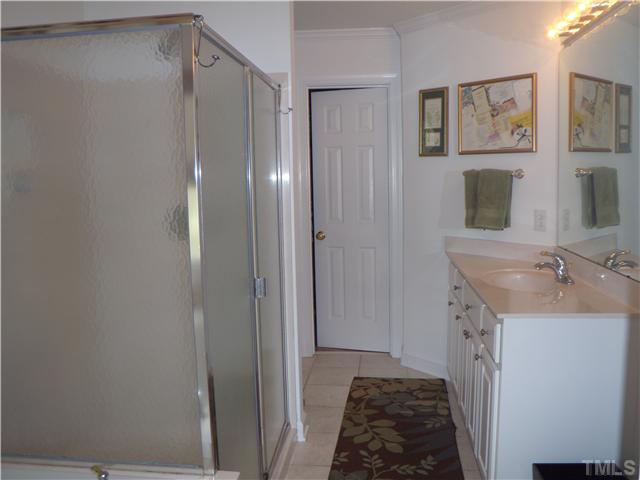 3809 La Costa Way Raleigh, NC 27610 - Photo 11 of 25 a bathroom with a sink and a mirror