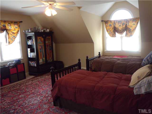 3809 La Costa Way Raleigh, NC 27610 - Photo 15 of 25 a bedroom with a bed and a chandelier