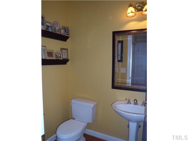 3809 La Costa Way Raleigh, NC 27610 - Photo 8 of 25 a bathroom with a toilet sink and mirror