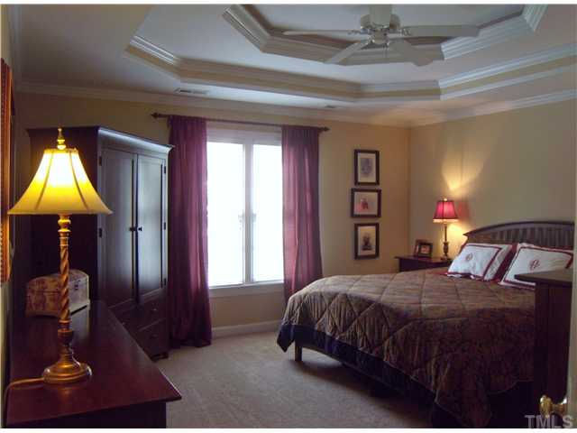 3809 La Costa Way Raleigh, NC 27610 - Photo 9 of 25 a bedroom with a bed and a chandelier