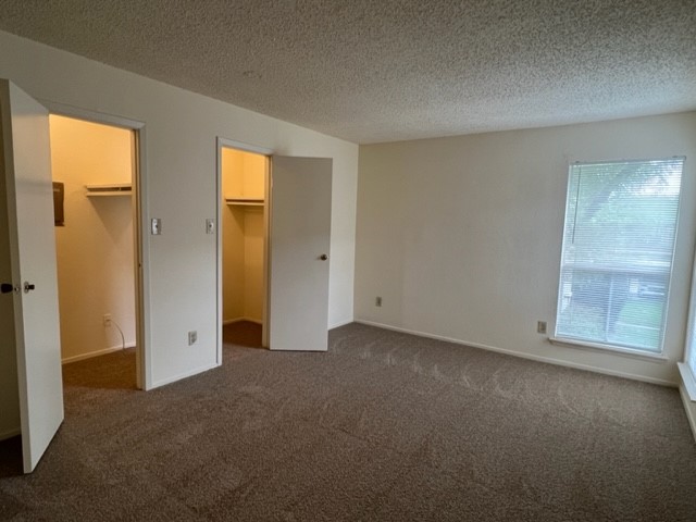 9229 Imogene Street, Unit 9229 Houston, TX 77036 - Photo 22 of 24 an empty room with windows and closet