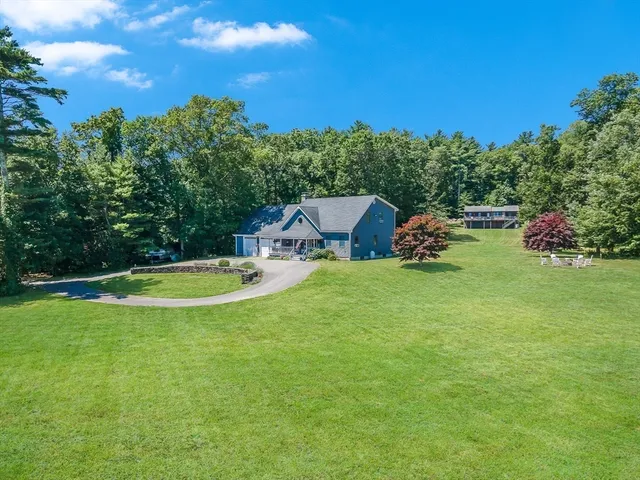 a view of a house with swimming pool and a yard
