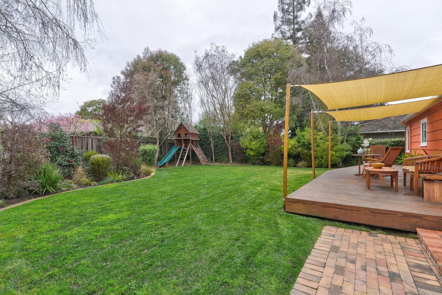 311 Concord Drive Menlo Park, CA 94025 - Photo 13 of 15 a view of a backyard with table and chairs under an umbrella