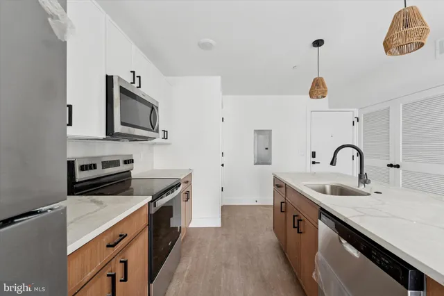a kitchen with stainless steel appliances granite countertop a sink and a stove