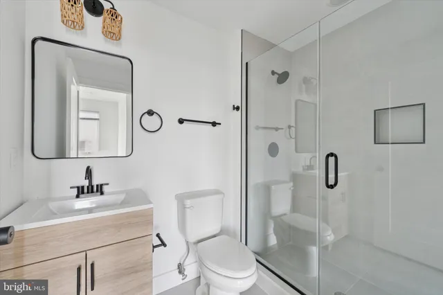 a bathroom with a toilet a sink and shower