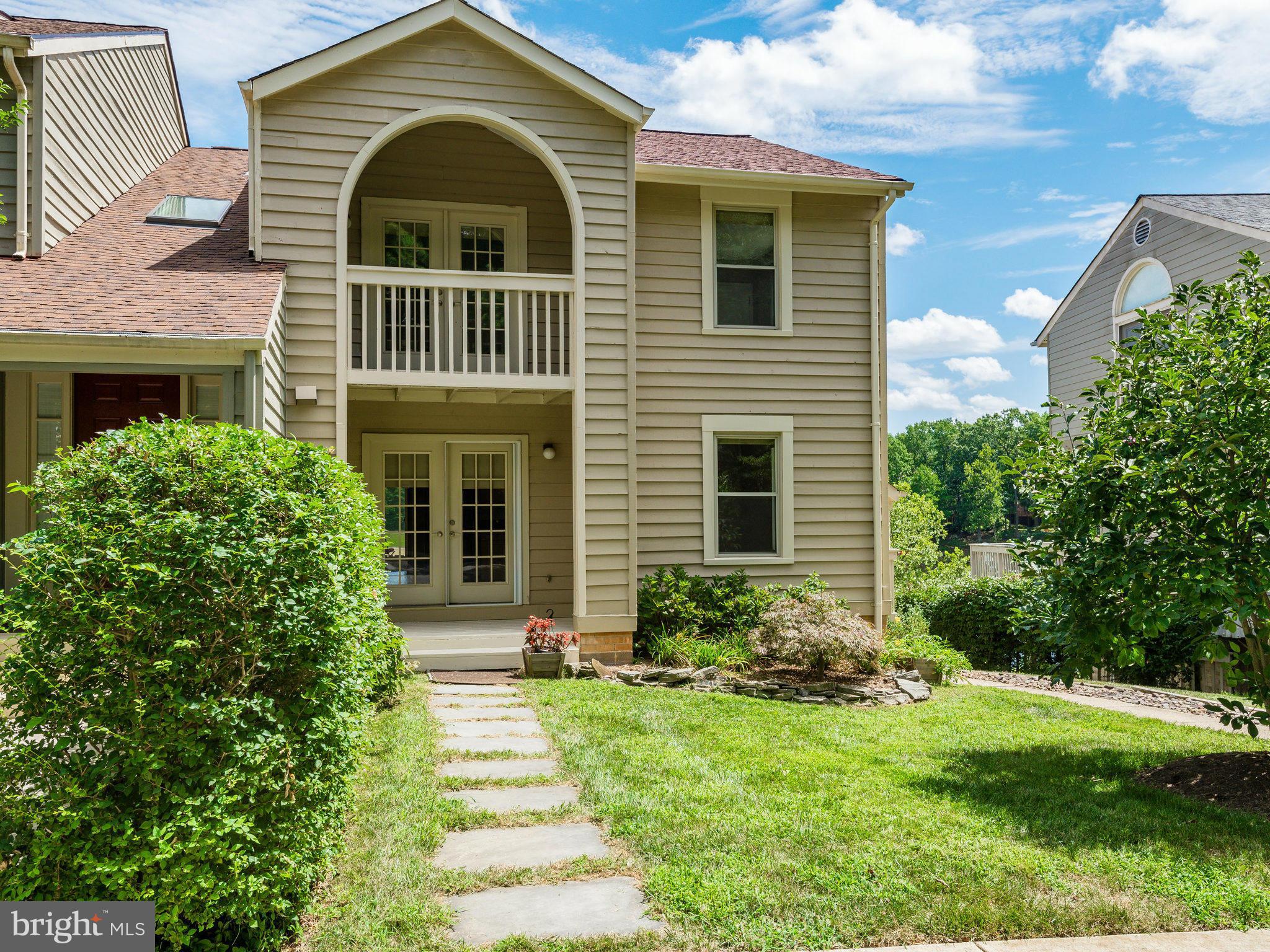 11131 Lake Chapel Lane Reston, VA 20191 - Photo 1 of 30 a view of a house with brick walls and a yard with plants
