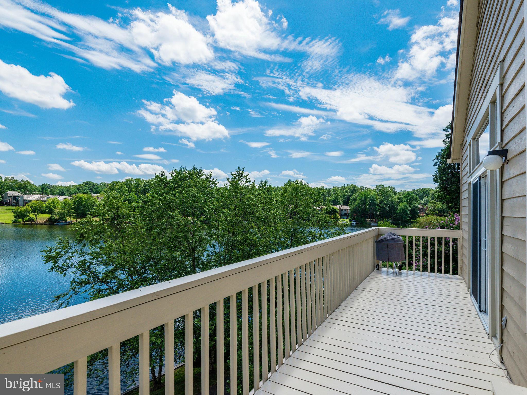 11131 Lake Chapel Lane Reston, VA 20191 - Photo 2 of 30 a balcony with wooden floor and fence