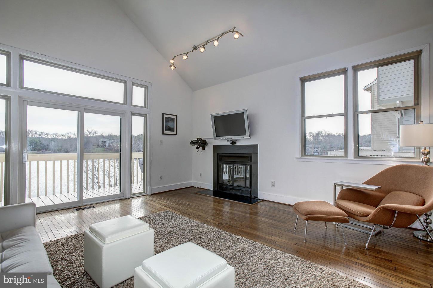 11131 Lake Chapel Lane Reston, VA 20191 - Photo 11 of 30 a living room with furniture a fireplace and a large window