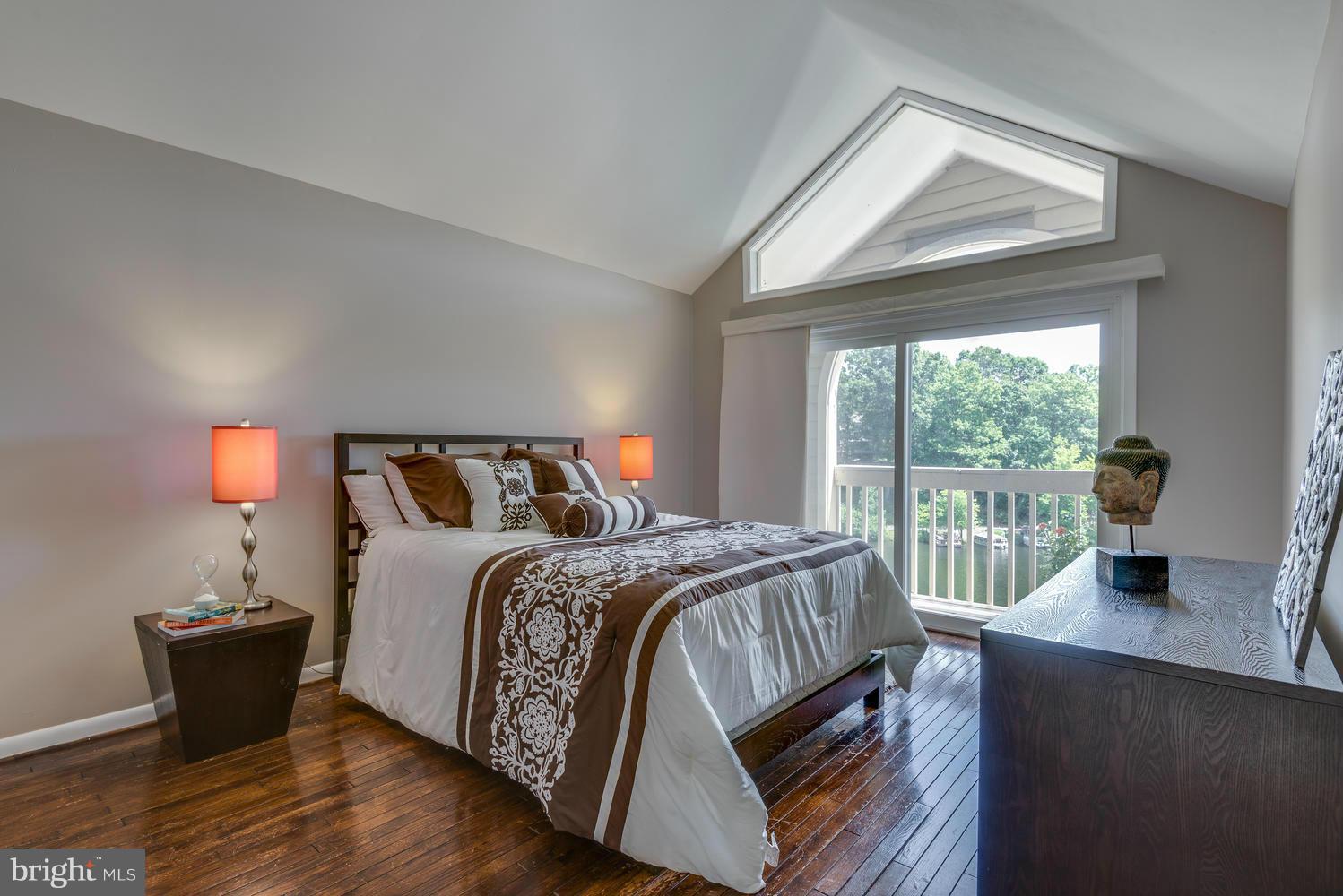 11131 Lake Chapel Lane Reston, VA 20191 - Photo 17 of 30 a bed sitting in a bedroom next to a window