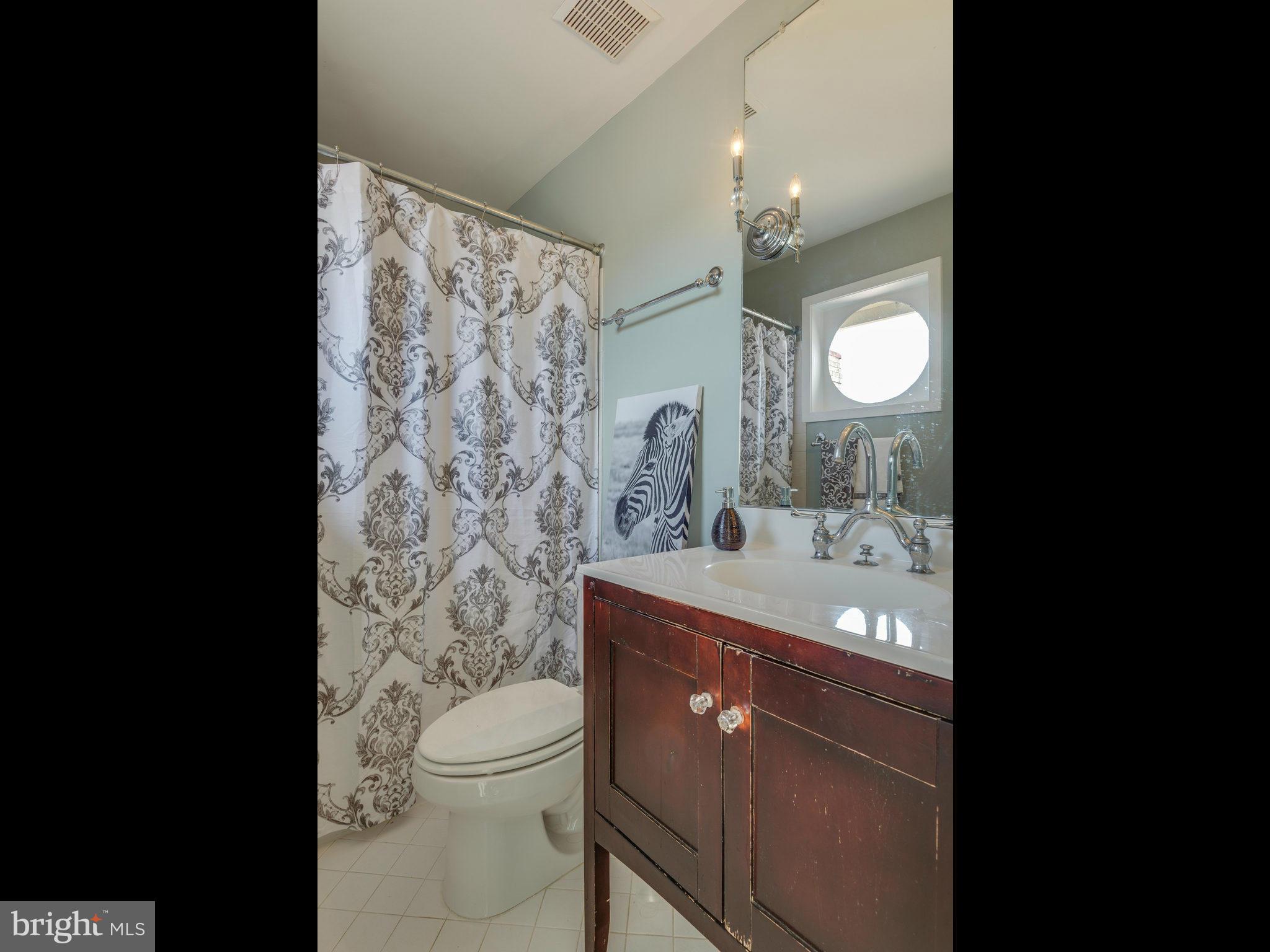 11131 Lake Chapel Lane Reston, VA 20191 - Photo 20 of 30 a bathroom with a toilet sink vanity granite and mirror