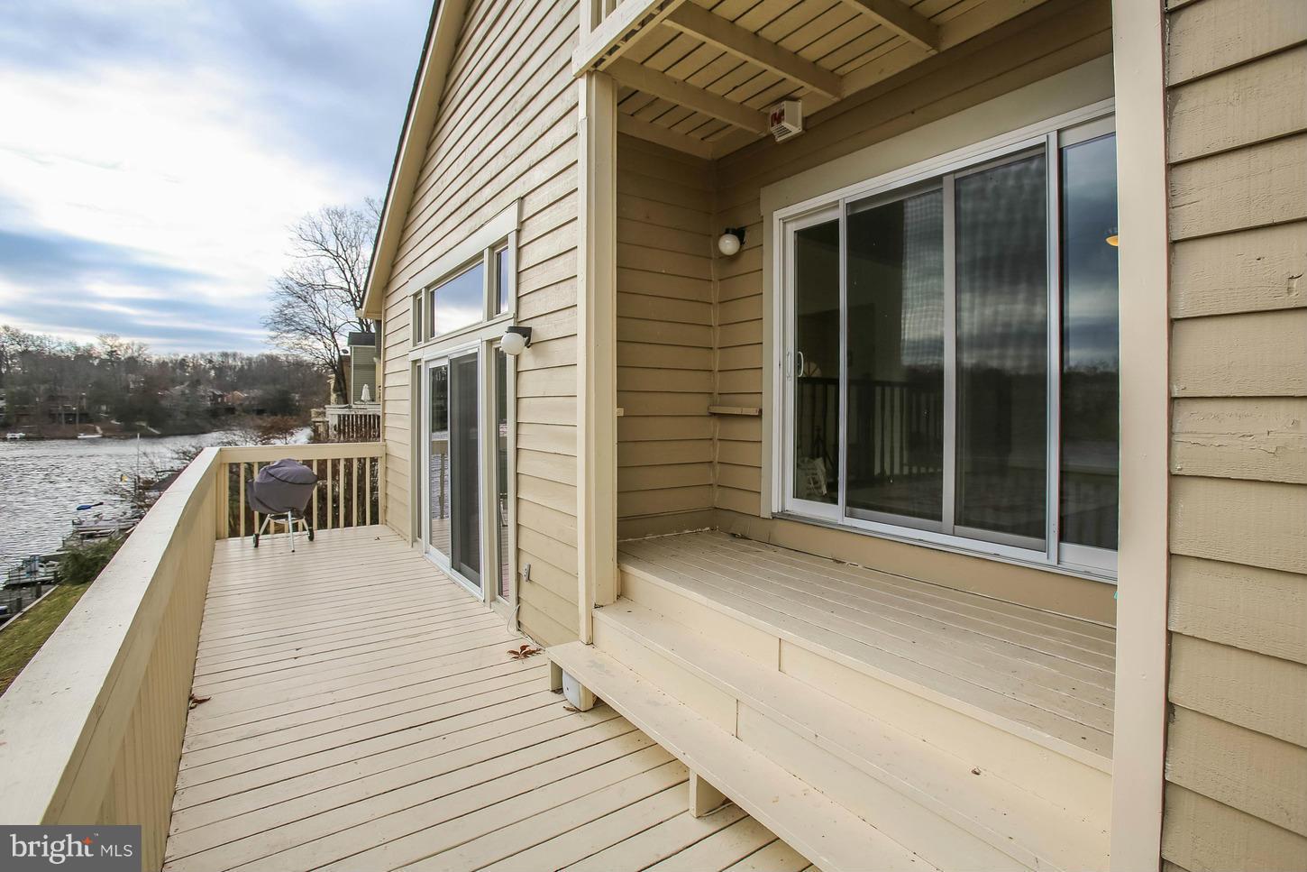 11131 Lake Chapel Lane Reston, VA 20191 - Photo 3 of 30 a view of a balcony with wooden floor and fence