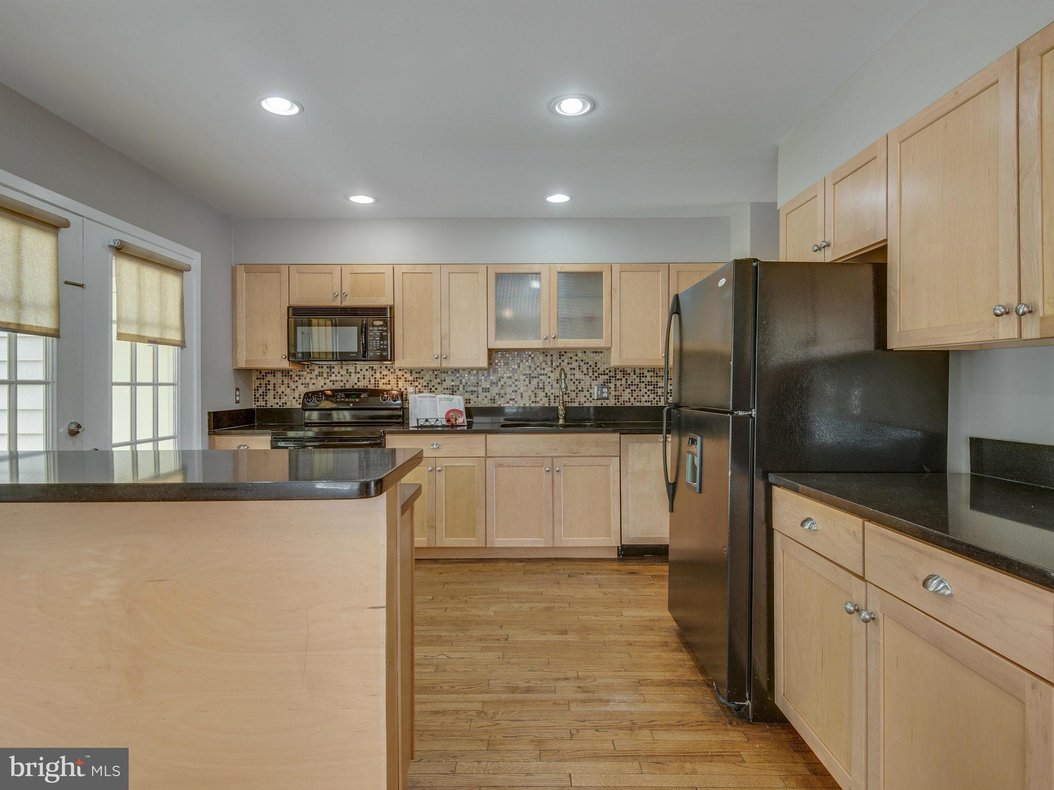 11131 Lake Chapel Lane Reston, VA 20191 - Photo 4 of 30 a kitchen with stainless steel appliances granite countertop a refrigerator sink and cabinets