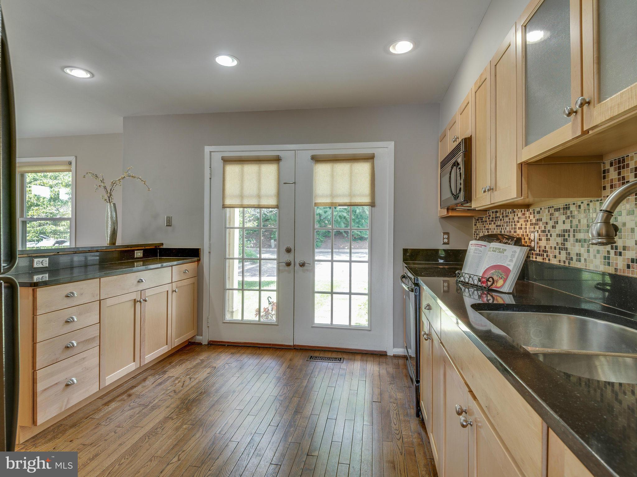 11131 Lake Chapel Lane Reston, VA 20191 - Photo 6 of 30 a kitchen with granite countertop a sink a counter space appliances and cabinets