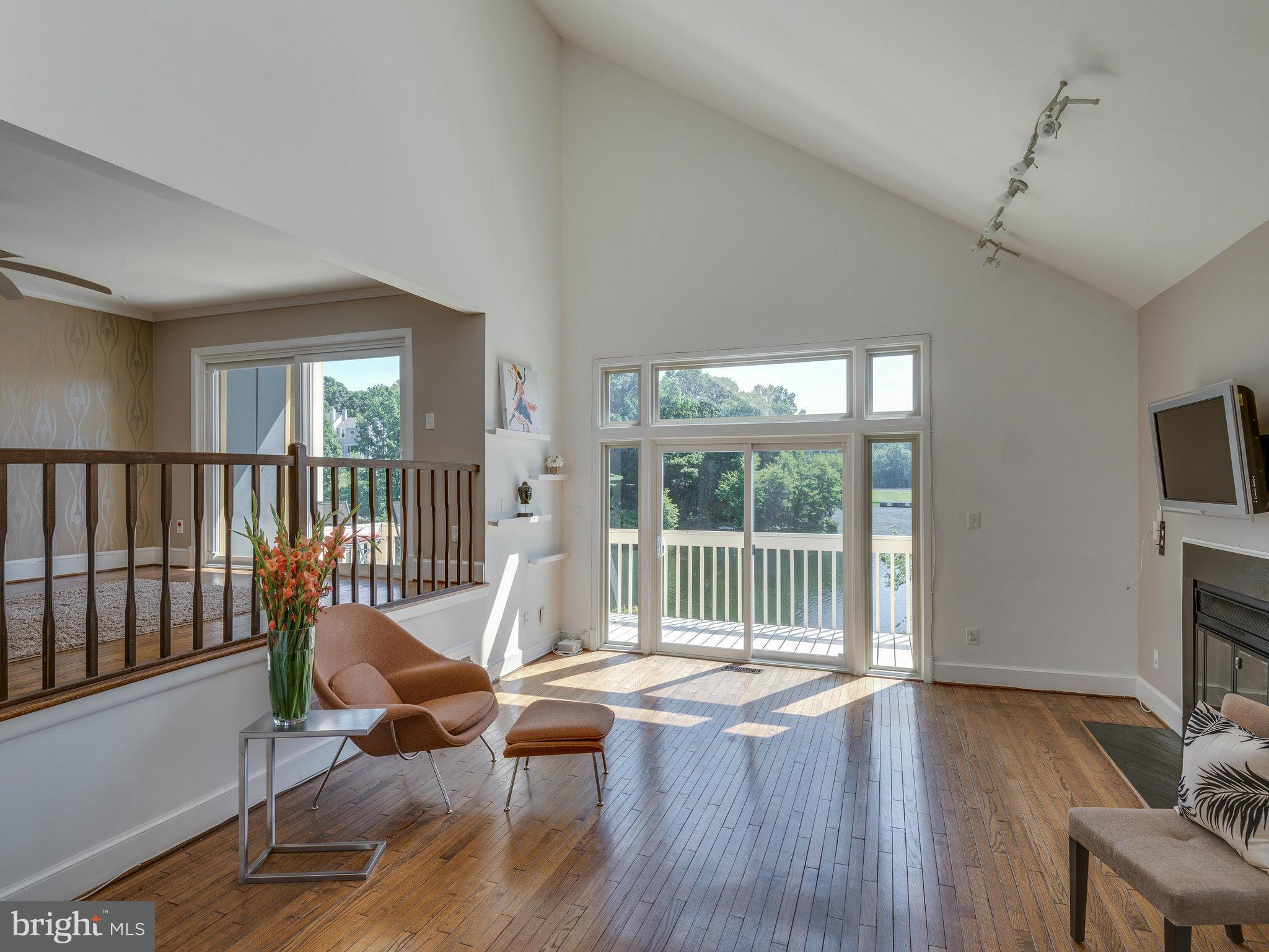 11131 Lake Chapel Lane Reston, VA 20191 - Photo 10 of 30 a living room with furniture floor to ceiling window and wooden floor