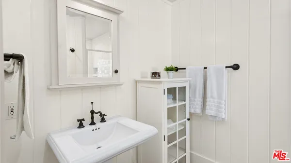 a bathroom with a granite countertop sink and a bathtub