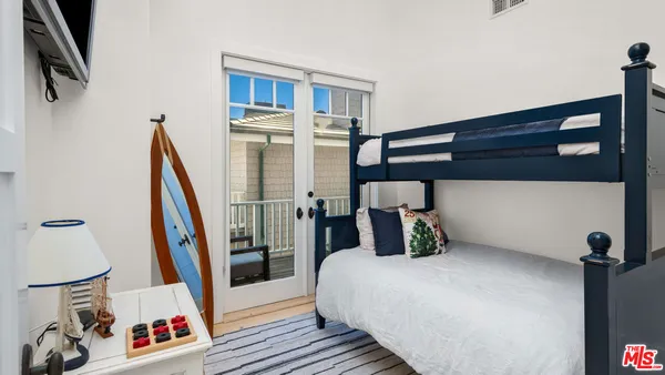 a bedroom with a bed and a painting on the wall