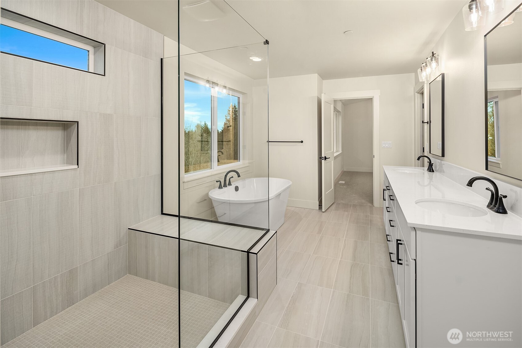 8409 Northeast 156th Street Kenmore, WA 98028 - Photo 12 of 16 a bathroom with a sink double vanity mirror and tub
