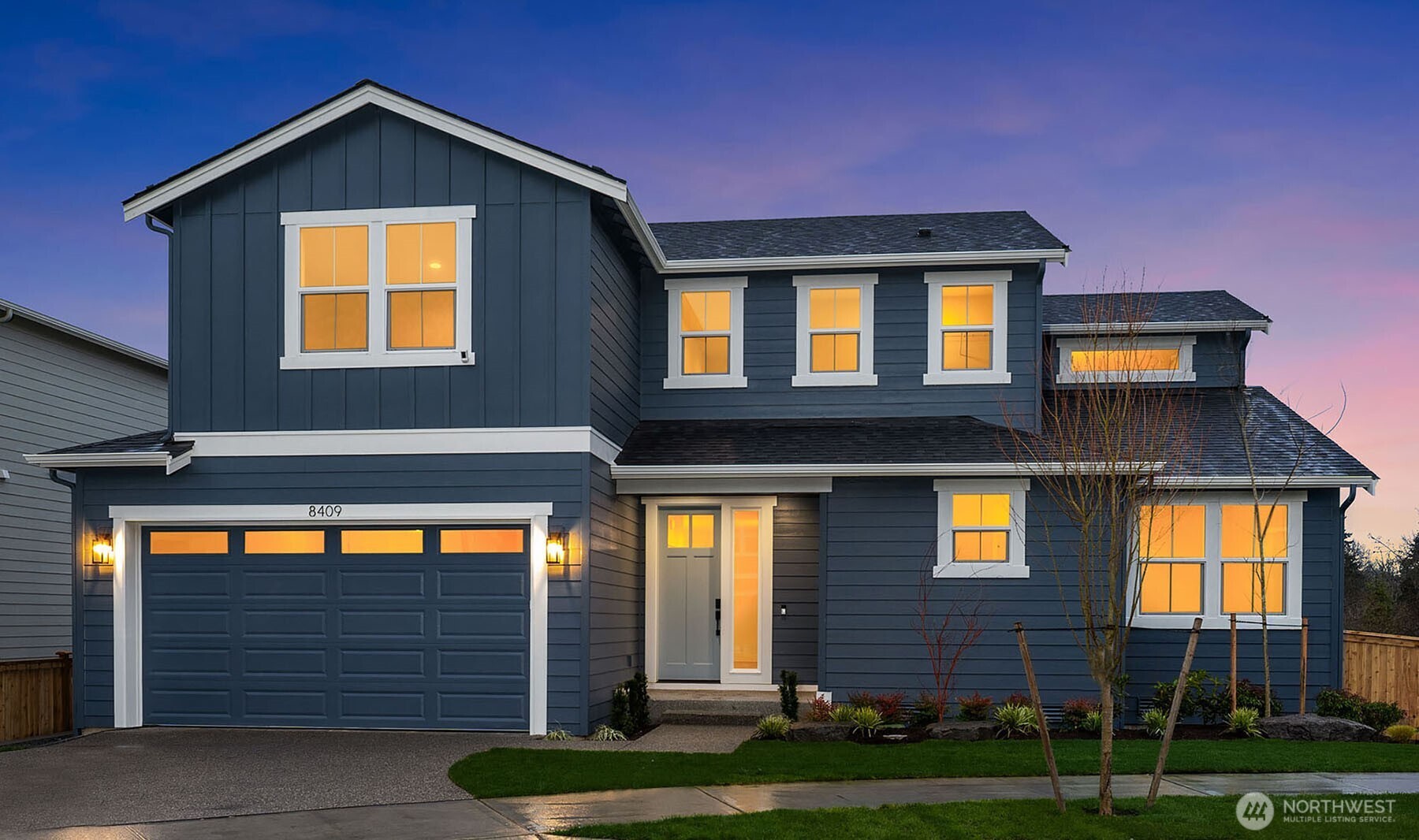 8409 Northeast 156th Street Kenmore, WA 98028 - Photo 2 of 16 a front view of a house with garden
