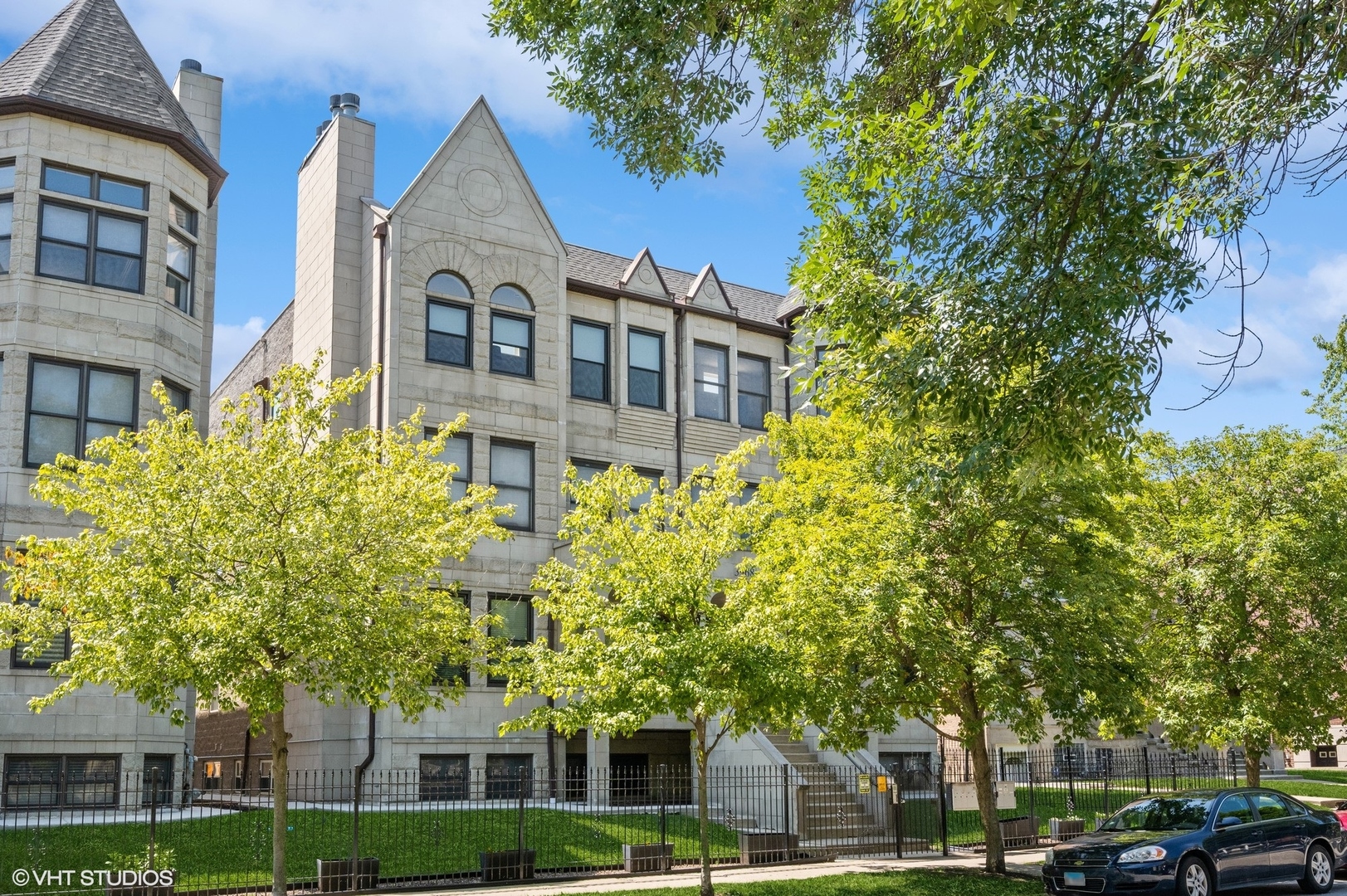 3968 South Ellis Avenue, Unit GS Chicago, IL 60653 - Photo 1 of 1 a front view of a residential apartment building with a yard